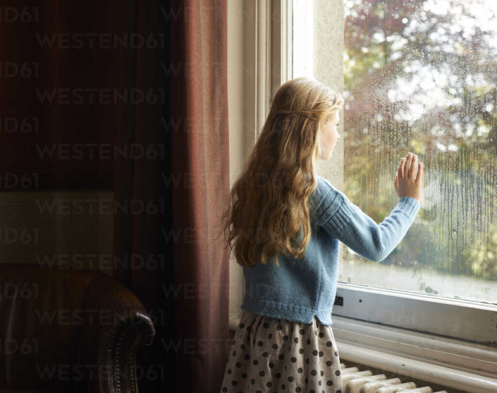 girl looking out window filled with confusion as to why her friend hasn't shown up